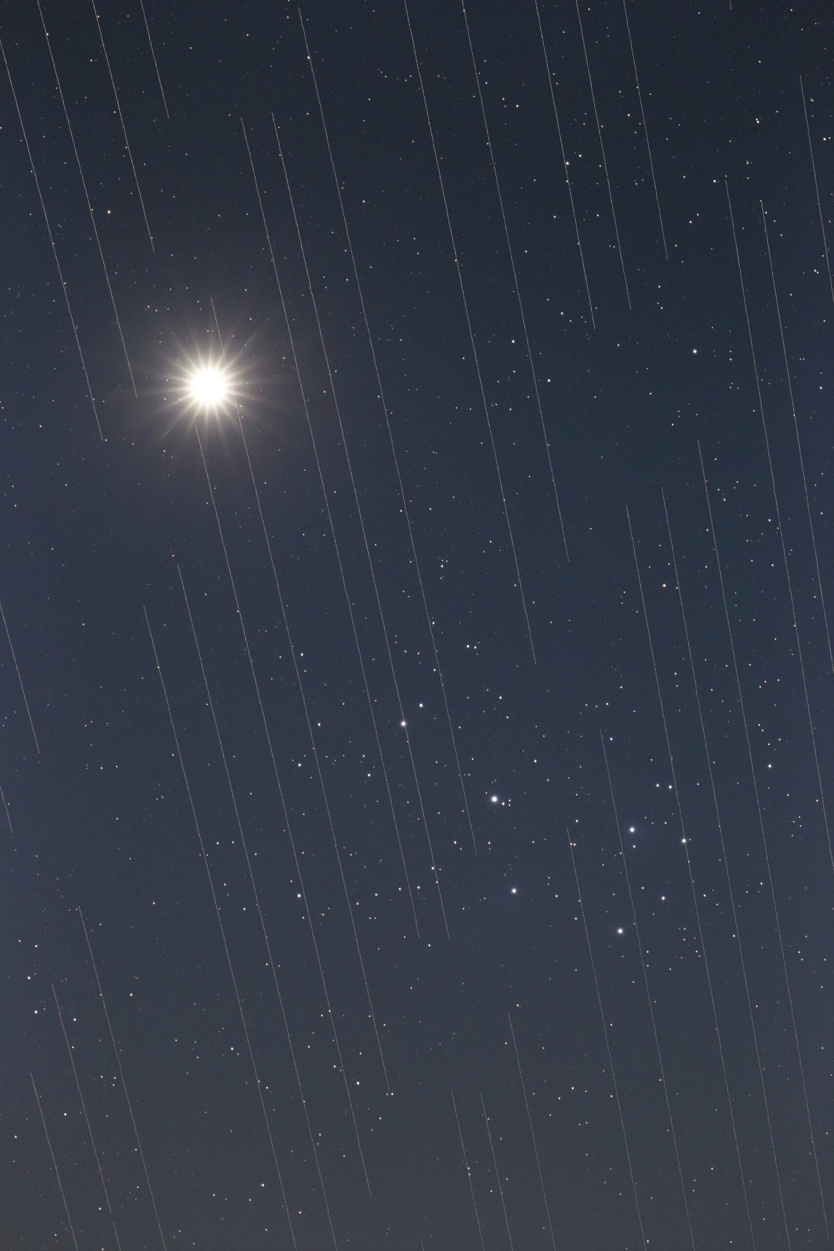 Image of Starlink satellites crossing in front of Venus and the Pleiades cluster. Credit - Torsten Hansen/IAU OAE