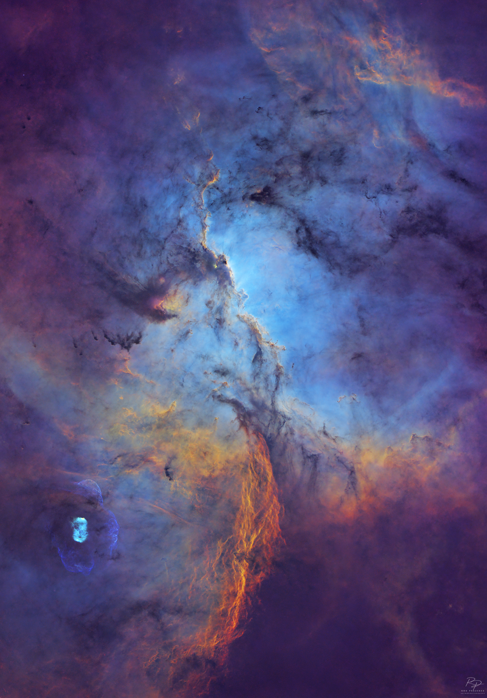 Shown is the deep region of the nebula, rich in gas surrounded by colorful stars and dense filaments of dark dust.