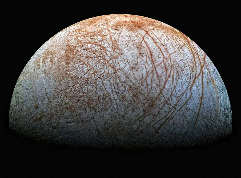 A photo of Jupiter's moon Europa shows ice and red-brown streaks.