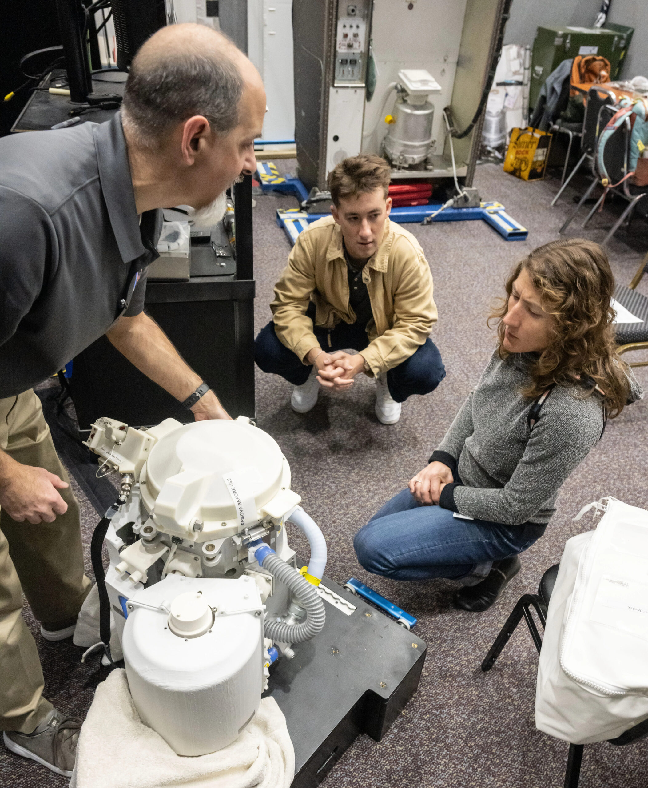 NASA astronaut Christina Koch works on an experimental version of the Orion space probe.