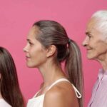 A conceptual illustration of a DNA double helix transforming into a glowing candle, representing the genetic component of human lifespan.