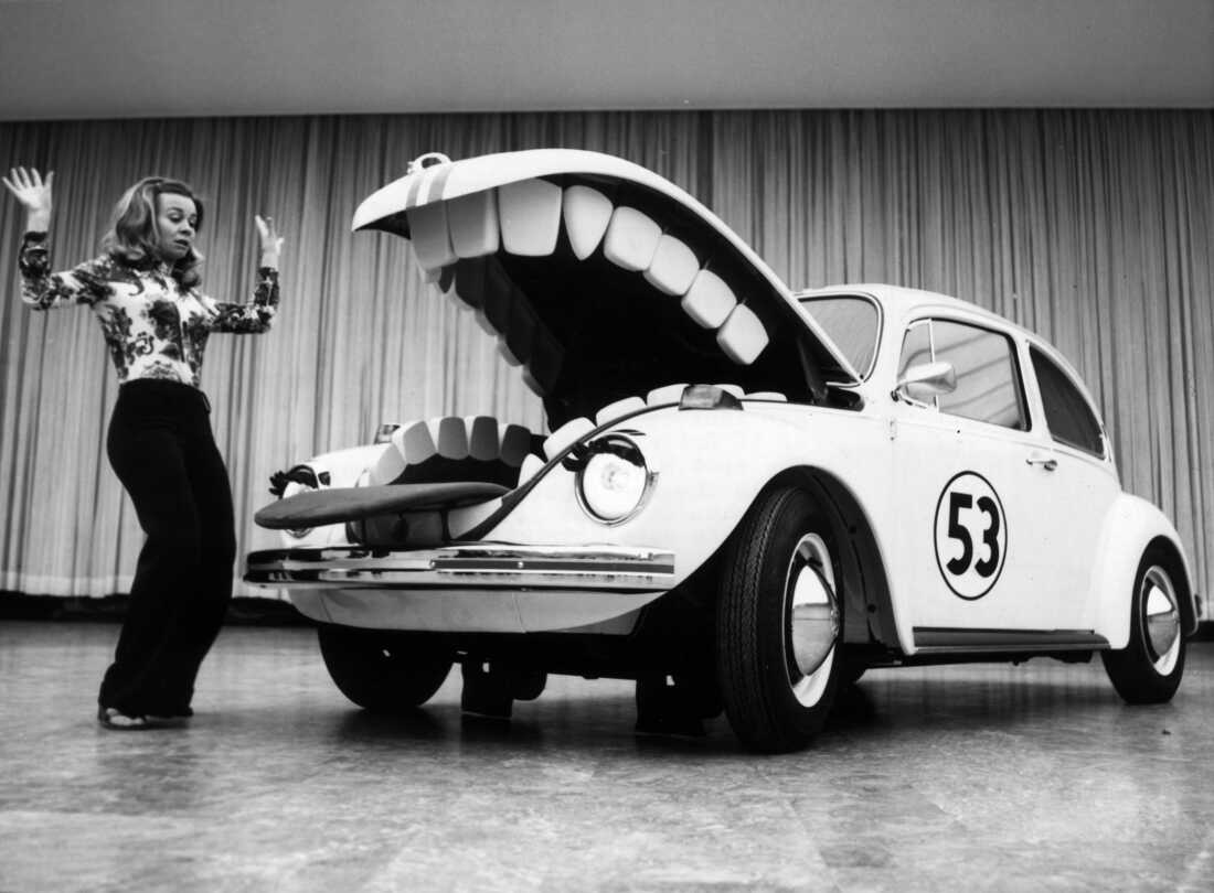 Herbie, an anthropomorphic Volkswagen Beetle from the 1969 Disney film. "The Love Bug" and its remains, terrorizing a young woman at a Berlin car show in June 1972. (Photo by Keystone/Hulton Archive/Getty Images)